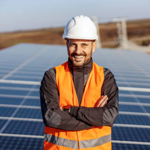 man standing in front of solar panels